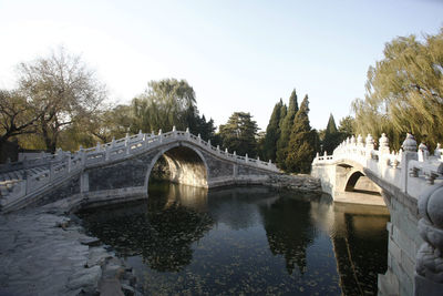 Arch bridge over river against sky