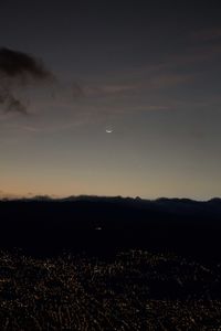 Scenic view of silhouette landscape against sky at night
