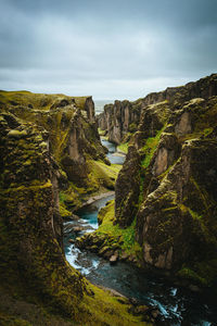 Scenic view of waterfall against sky