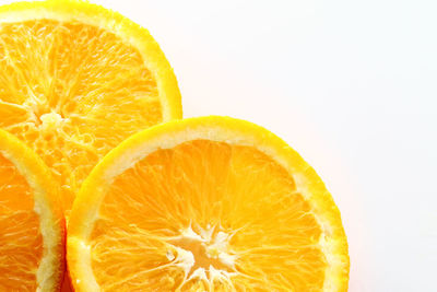 Close-up of orange slice against white background