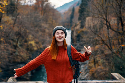 Portrait of smiling young woman standing outdoors