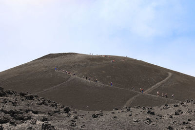 Trekking of hikers and tourists who walk on etna volcano crater -sicily