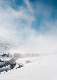 Snow covered road against sky