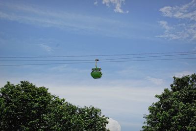 Low angle view of trees against blue sky