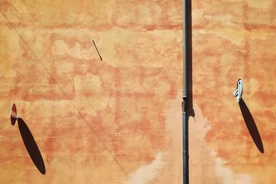 High angle view of metal pole against wall