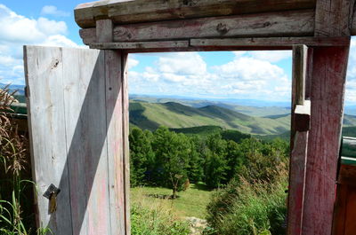 Panoramic shot of countryside landscape against mountain range