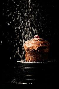 Close-up of chocolate cake against black background