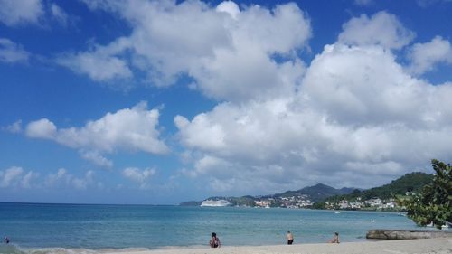 View of beach against cloudy sky