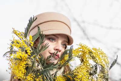 A  woman with a yellow acacia flowers. the concept of the spring - march 8, easter, women's day.
