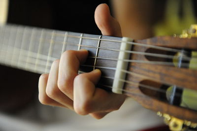 Close-up of hands playing guitar