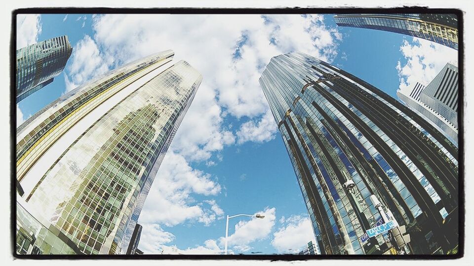 architecture, building exterior, built structure, low angle view, transfer print, city, modern, skyscraper, sky, tall - high, office building, tower, auto post production filter, glass - material, building, cloud - sky, cloud, capital cities, reflection, day