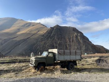 Built structure on land against mountain range