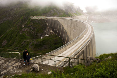 High angle view of woman and child posing on dam