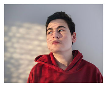 Portrait of young man against wall