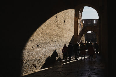 Group of people walking in front of historic building