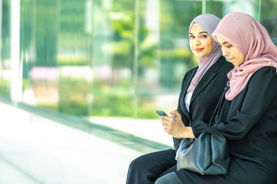 Young woman using mobile phone outdoors