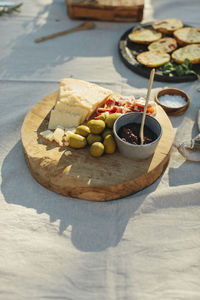 Cheese and olives on wooden board