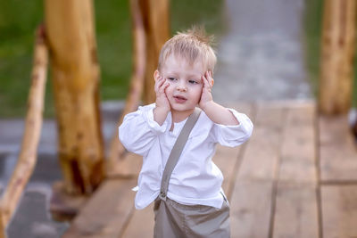 Portrait of cute boy standing outdoors