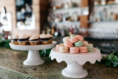 Macaroon and cupcakes on table 