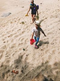 High angle view of boy playing with toy on beach