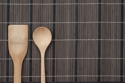 Directly above shot of wooden spoon on place mat