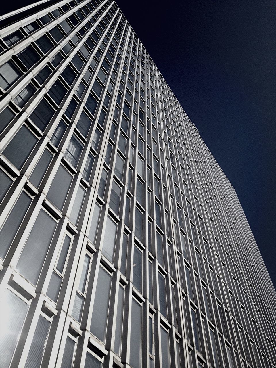 architecture, built structure, low angle view, building exterior, modern, office building, skyscraper, city, tall - high, building, glass - material, tower, sky, reflection, pattern, night, window, illuminated, no people, outdoors