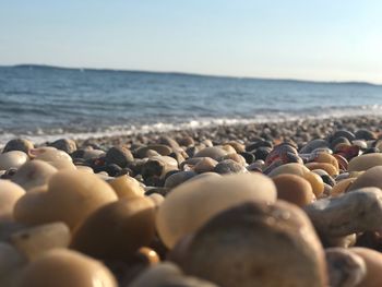 Pebbles on beach against sky