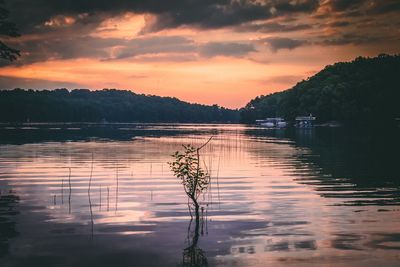 Scenic view of lake against orange sky