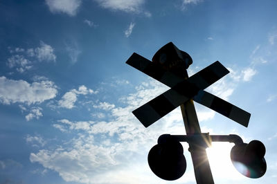 Low angle view of traffic signal against sky