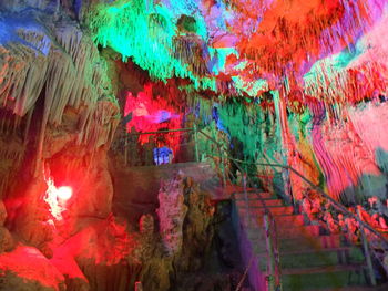 Low angle view of illuminated rock formation in water