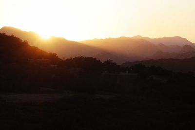 Scenic view of silhouette mountains against sky during sunset