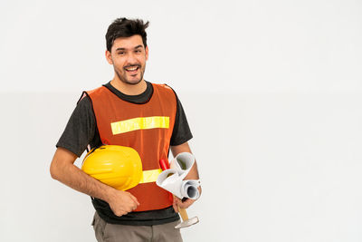 Portrait of smiling man standing against white background