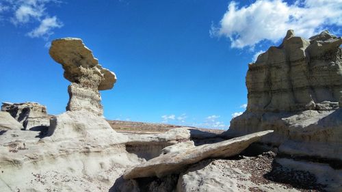 Low angle view of rock formations against blue sky