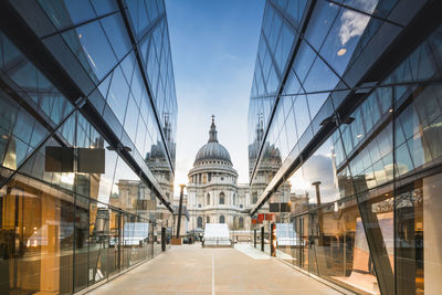 St pauls cathedral reflected in glass walls of one new change in london