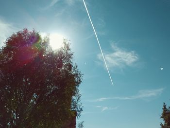 Low angle view of vapor trail against blue sky