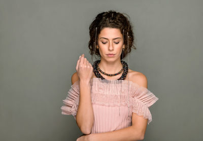 Portrait of a beautiful young woman against white background