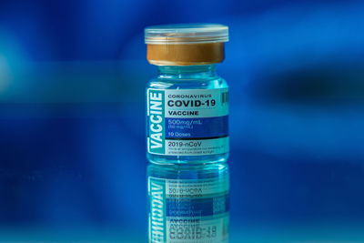 Close-up of bottle against blue background