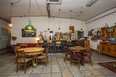 Chairs and tables in cafe against building