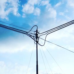 Low angle view of electricity pylon against sky