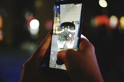 Close-up of hand holding mobile phone
