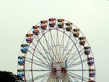 Low angle view of ferris wheel against sky