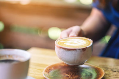 Close-up of coffee cup on table at cafe