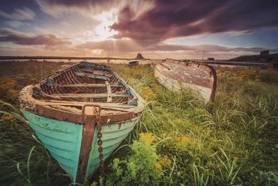 Old boats on grass at the beach