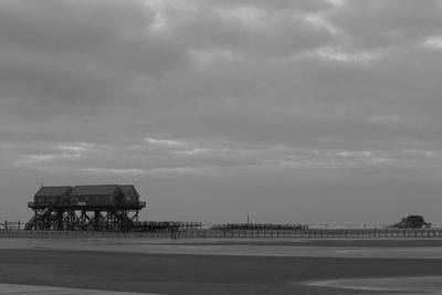 Lifeguard hut on beach by sea against sky