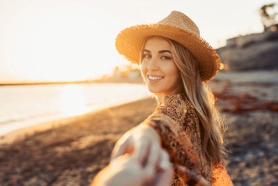 Portrait of young woman wearing hat