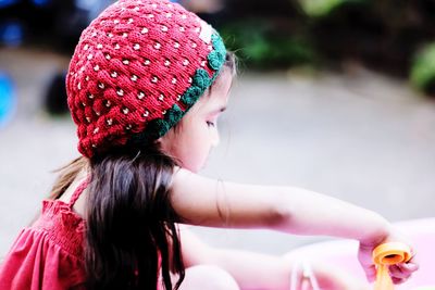 Side view of girl wearing knit hat