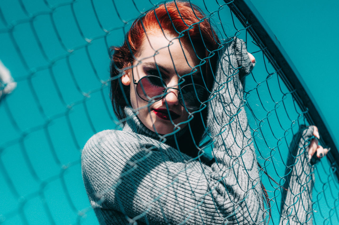 one person, portrait, young adult, headshot, real people, young women, women, fence, lifestyles, barrier, looking at camera, clothing, leisure activity, boundary, hairstyle, long hair, day, chainlink fence, outdoors, beautiful woman