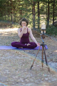 Portrait of woman sitting on field