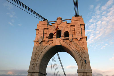 Low angle view of amposta suspension bridge against sky