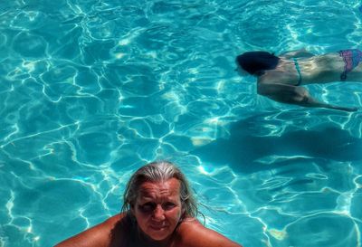 High angle view of woman swimming in swimming pool